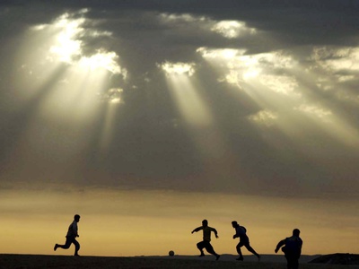 Iraqi Kurdish Boys Play Football as the Sun Sets