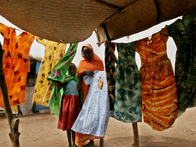Buy A Sudanese Woman Buys a Dress for Her Daughter at the Zamzam Refugee Camp at AllPosters.com