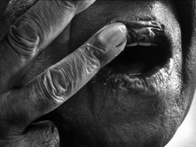 Jazz Trumpeter Louis Armstrong Massaging Lips with Balm to Keep Them Strong for Playing His Trumpet