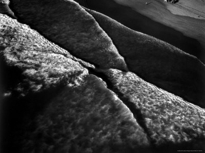 Aerial of Horseback Riders Guiding Their Horses Along Shore at High Tide at Ocean Beach