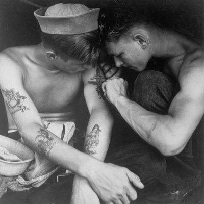 American Sailor Having Another Tattoo Done by Shipmate Aboard Battleship USS New Jersey During WWII