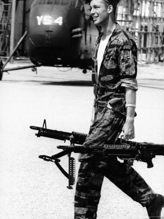 Yankee Papa 13 Helicopter Crew Chief James Farley Carrying a Pair of M-60 Machine Guns