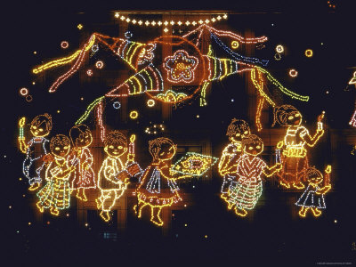 Lit Display of Traditional Pinata and Children in Candlelight Procession During Christmas Festival