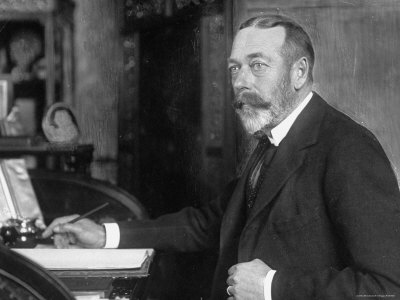 British monarch George V (1865-1936) E. O. Hoppe seated at writing desk in Buckingham Palace