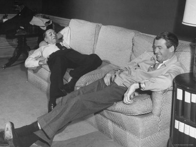 James Stewart Stretched Out on Office Sofa, Smiling, Producer Leland Hayward Slouches at Other End