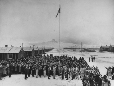Nisei Japanese Americans Participating in Flag Saluting Ceremony at Relocation Center During WWII