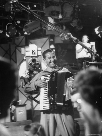 Bandleader Lawrence Welk Playing Accordion Amidst Cameramen on the Set of Weekly TV Show