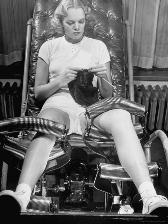 Pat Ogden at Slenderizing Salon Knitting in Padded Chair While Leg Rollers Work from Thigh to Ankle