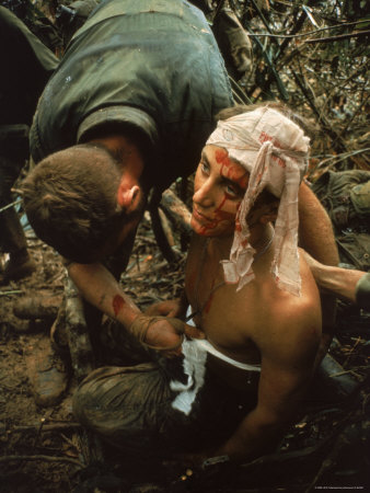 Shell Shocked American Marine Getting Wounds Bandaged in Muddy Jungle During OP Prairie