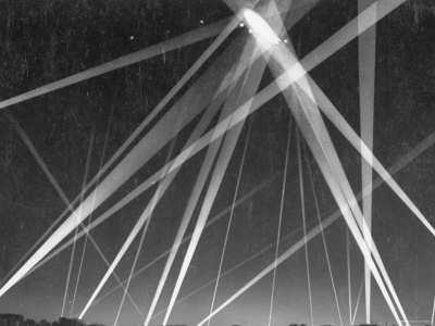 British Civilian Defense Forces Fire on German Navy Airship Caught in Searchlights Overhead