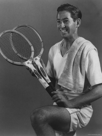 Tennis Pro Bobby Riggs Posing with Two Tennis Racquets