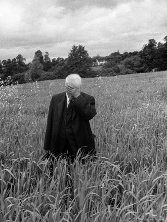 Poet Robert Frost Standing in Oxford Field with His Hand over His Face