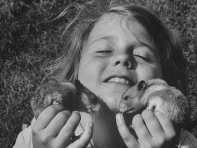 Shelley Silk, Daughter of Photographer George Silk, Ecstatically Cuddling Her Two Pet Hamsters
