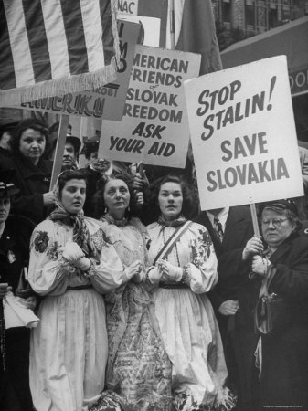 Czech Women Kneeling in Prayer During Protest Outside Hotel Hosting Peace Conference
