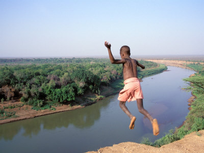 Buy Karo Boy Leaps Off a Cliff Over the Omo River, Ethiopia at AllPosters.com