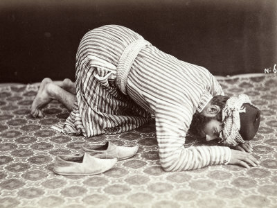 A Man, Kneeling Down, is Rapt in Prayer