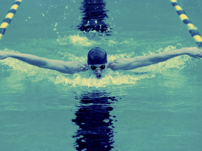 Young Man Swimming the Butterfly Stroke