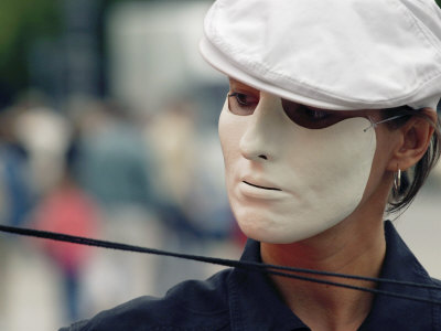 Buy A Street Performer Wears a Mask Concealing Her Expression at AllPosters.com