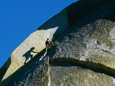 Buy A Rock Climber Scales the Flat Rock Surface of a Cliff Near Needles, California at AllPosters.com