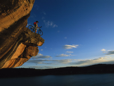 Buy A Cyclist Atop a Rock Overhang Near Dolores, Colorado at AllPosters.com
