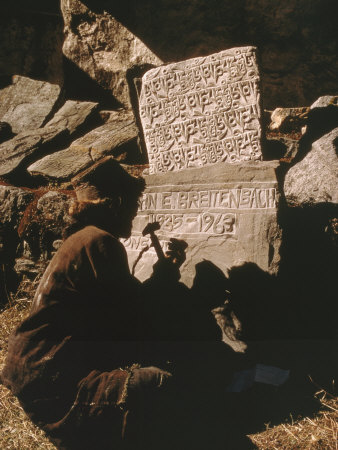 Buy A Man Inscribes a Stone Marker with the Name of a Climber Killed on Mount Everest at AllPosters.com