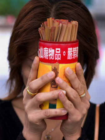 Woman Holding Prayer Sticks at Wong Tai Sin Temple, Kowloon, China
