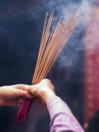 Worshipper Burning Incense in the Wong Tai Sin Temple, Kowloon, China