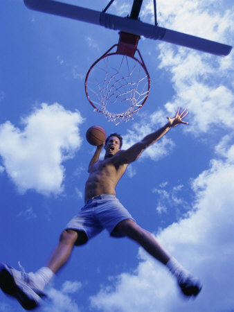 Low Angle View of a Young Man Slam Dunking a Basketball Poster