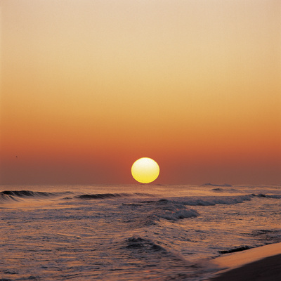 Yellow Sun in Sunset Over Ocean Waves
