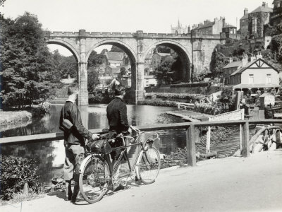 Buy Two Cyclists Take a Break on a Bridge Over the River Nidd at Knaresborough at AllPosters.com