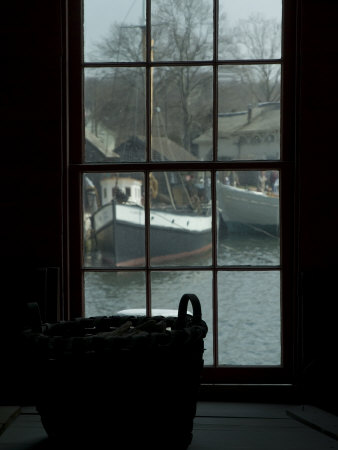 Looking Out Through a Window at Wooden Fishing Boats on a River