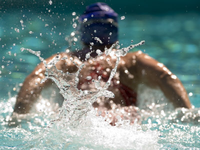 Young Woman Swimming the Butterfly Stroke in a Swimming Pool, Bainbridge Island, Washington, USA