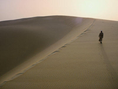 Arab Walking on a Large Sand Dune