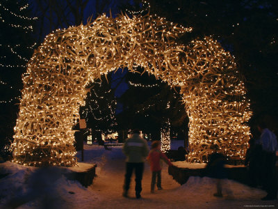 Buy An Arch Built of Antlers is Covered in Lights at the Town Square at AllPosters.com
