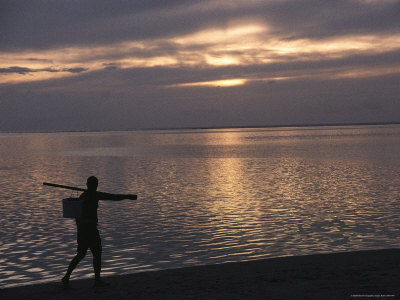 Tahitian Fisherman Walks along the Beach at Sunset