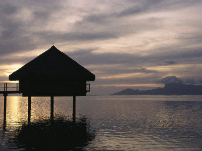 Tahitian Over-Water Bungalow at Sunset with Moorea Island in Distance