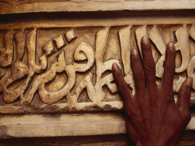 A Man Runs His Hand Over Arabic Script at the Famous Jama Masjid