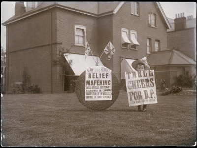 Three Cheers for B P: Relief of Mafeking is Hailed by a Patriotic British Boy in His Garden
