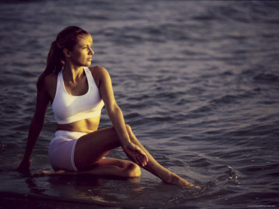 Young Woman Meditating at the Beach