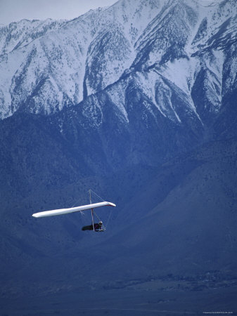 Hang Glider in Front of a Snow Capped MOuntain Poster