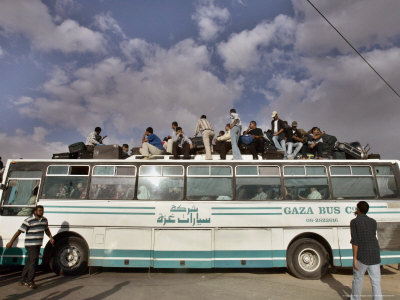 Palestinians Sit on Top of a Bus
