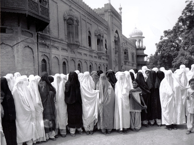 Pathan Women Observe Strict Muslim Purdah as They Come out to Vote at a High School