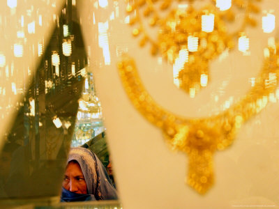 An Afghan Woman Looks for Gold at a Gold Shop