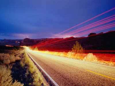 Vehicle Lights and Lightning Illuminating Road, Arches National Park, Utah, USA