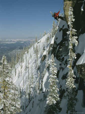 Buy Man Rappels Down Red Mountain with a Snowboard on His Back at AllPosters.com