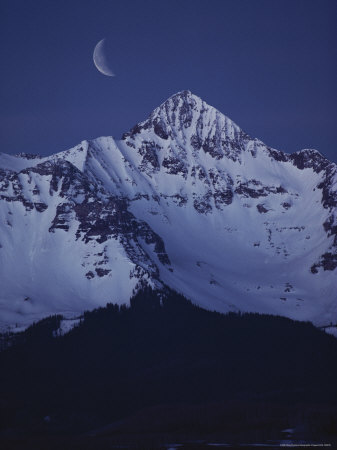 Buy Quarter Moon Sits Above the Snow-Capped Mountains at Night at AllPosters.com