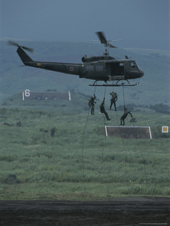 Soldiers Rappel From a Helicopter During Training Exercises