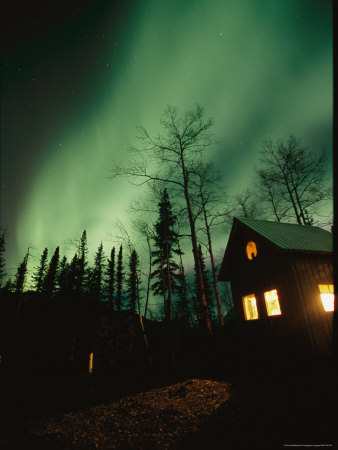 Buy Aurora Borealis Fills the Sky over a Warmly Lit Cabin at AllPosters.com