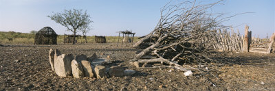 Buy Clump of Rocks and Cut Trees Lie on the Ground in a Himba Community at AllPosters.com