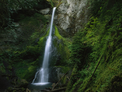 Waterfall Cascading Down Moss-Covered Rock Face